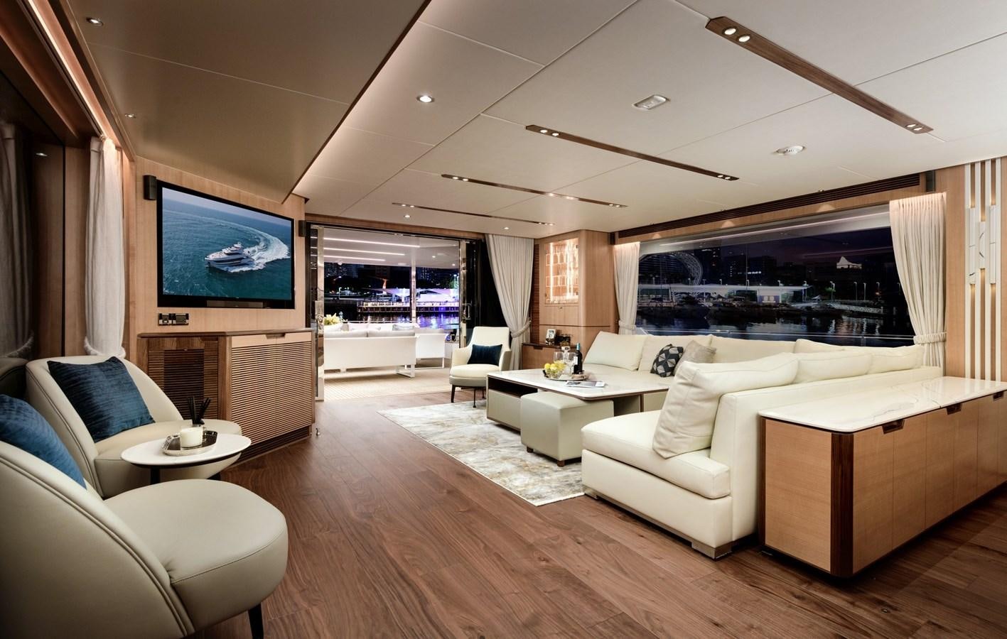 a living room with a large screen aboard CHRISTINE Yacht for Sale