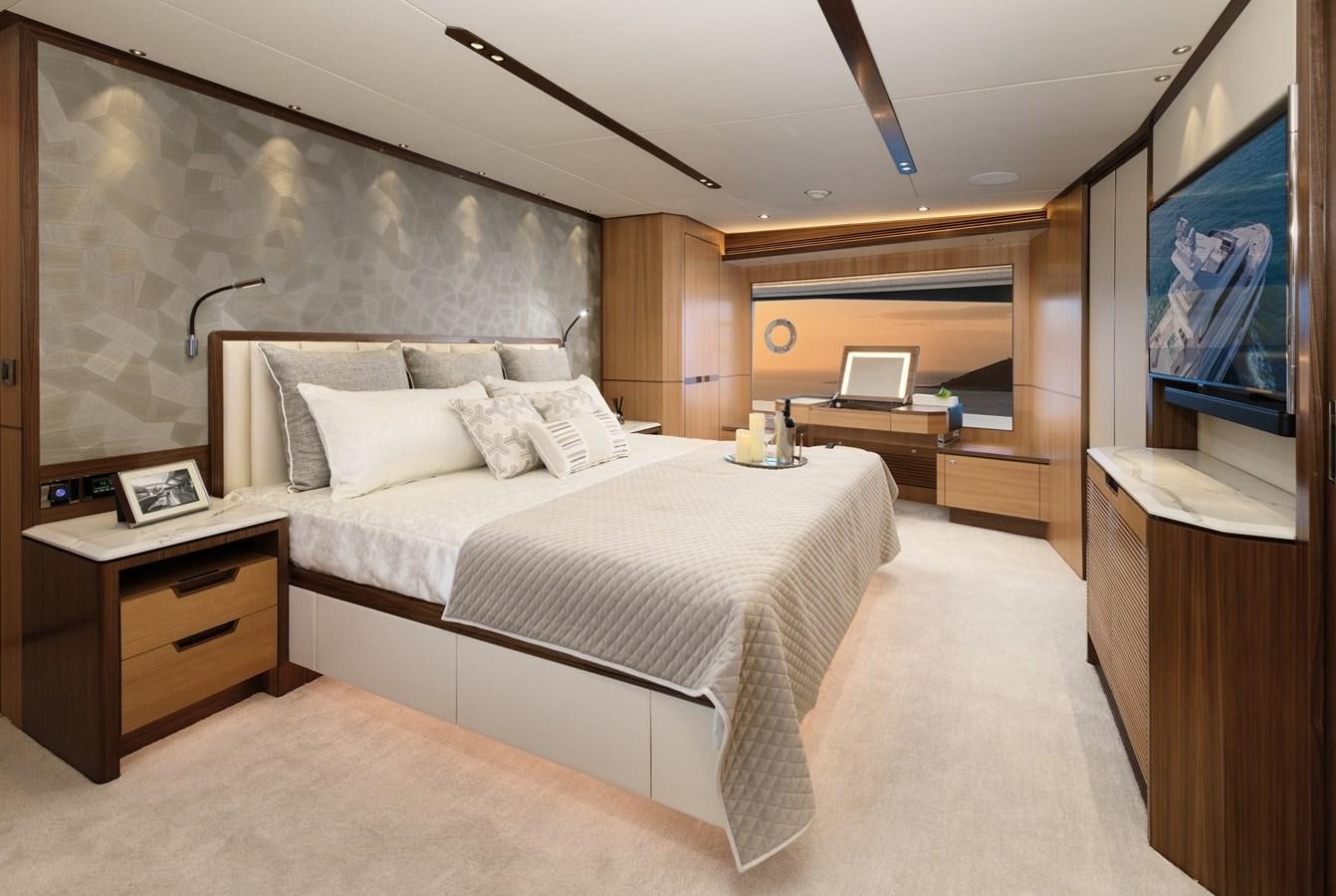 a bedroom with a bed and a tv aboard CHRISTINE Yacht for Sale