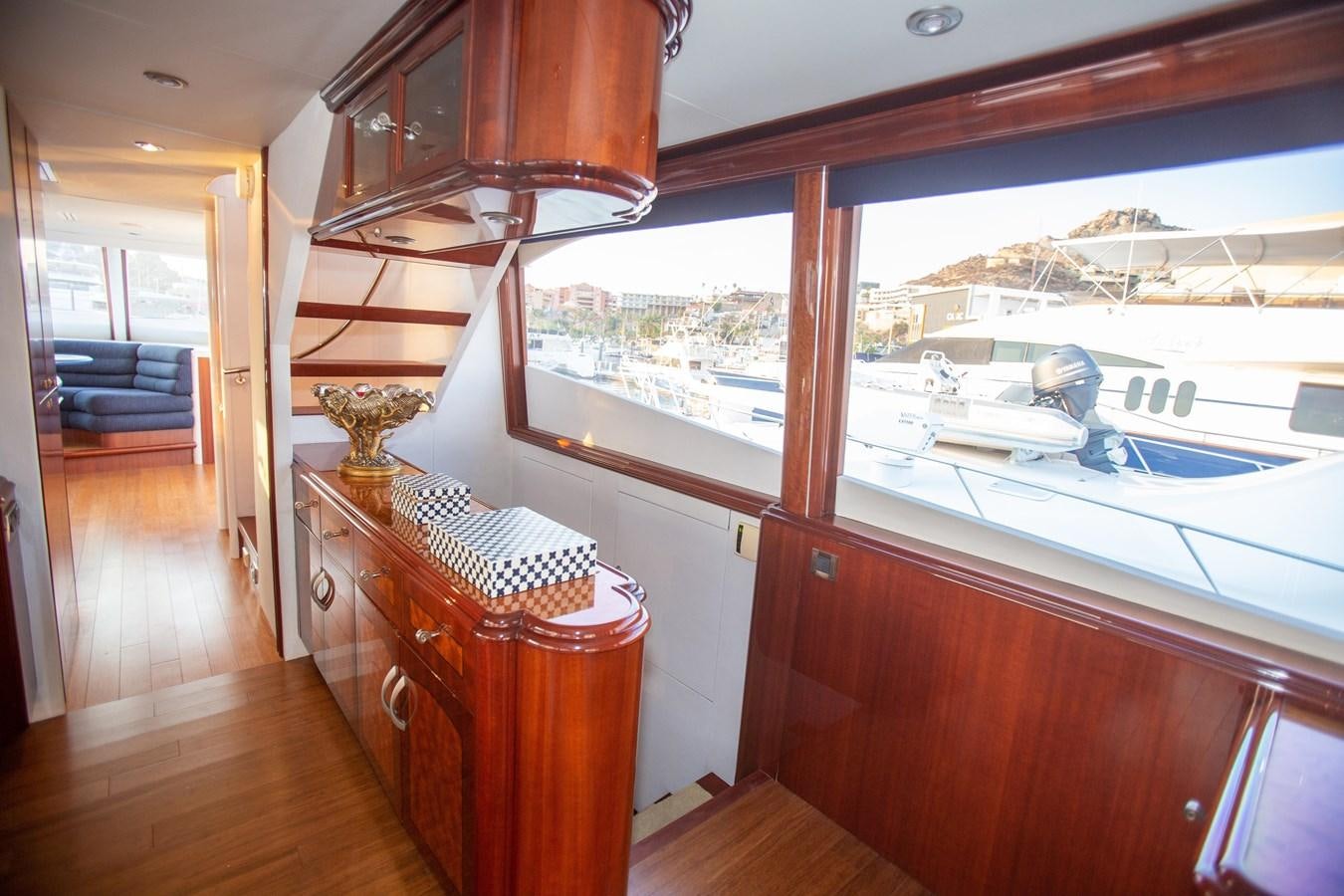 a room with a boat and a table and a lamp aboard LAZZARA 80' Yacht for Sale