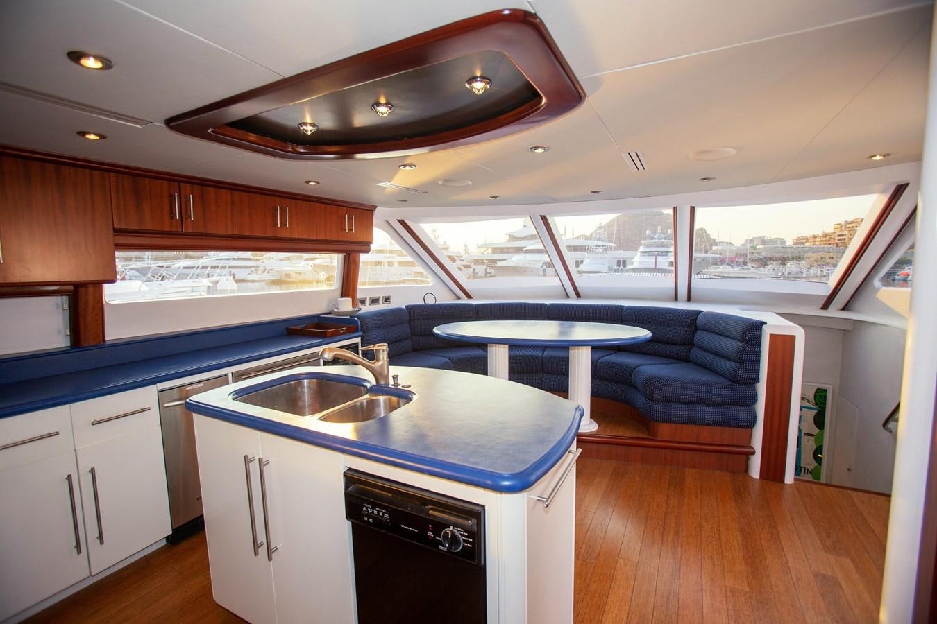 a kitchen with a table and a sink aboard LAZZARA 80' Yacht for Sale
