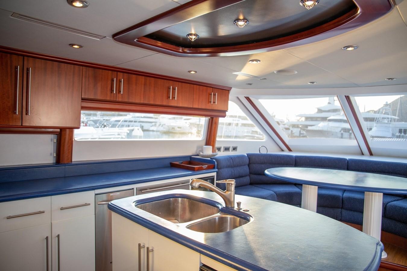 a kitchen with a large window aboard LAZZARA 80' Yacht for Sale