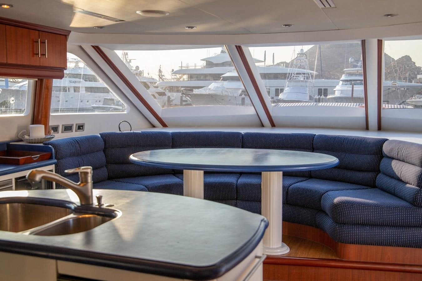 a kitchen and living room with a pool table aboard LAZZARA 80' Yacht for Sale