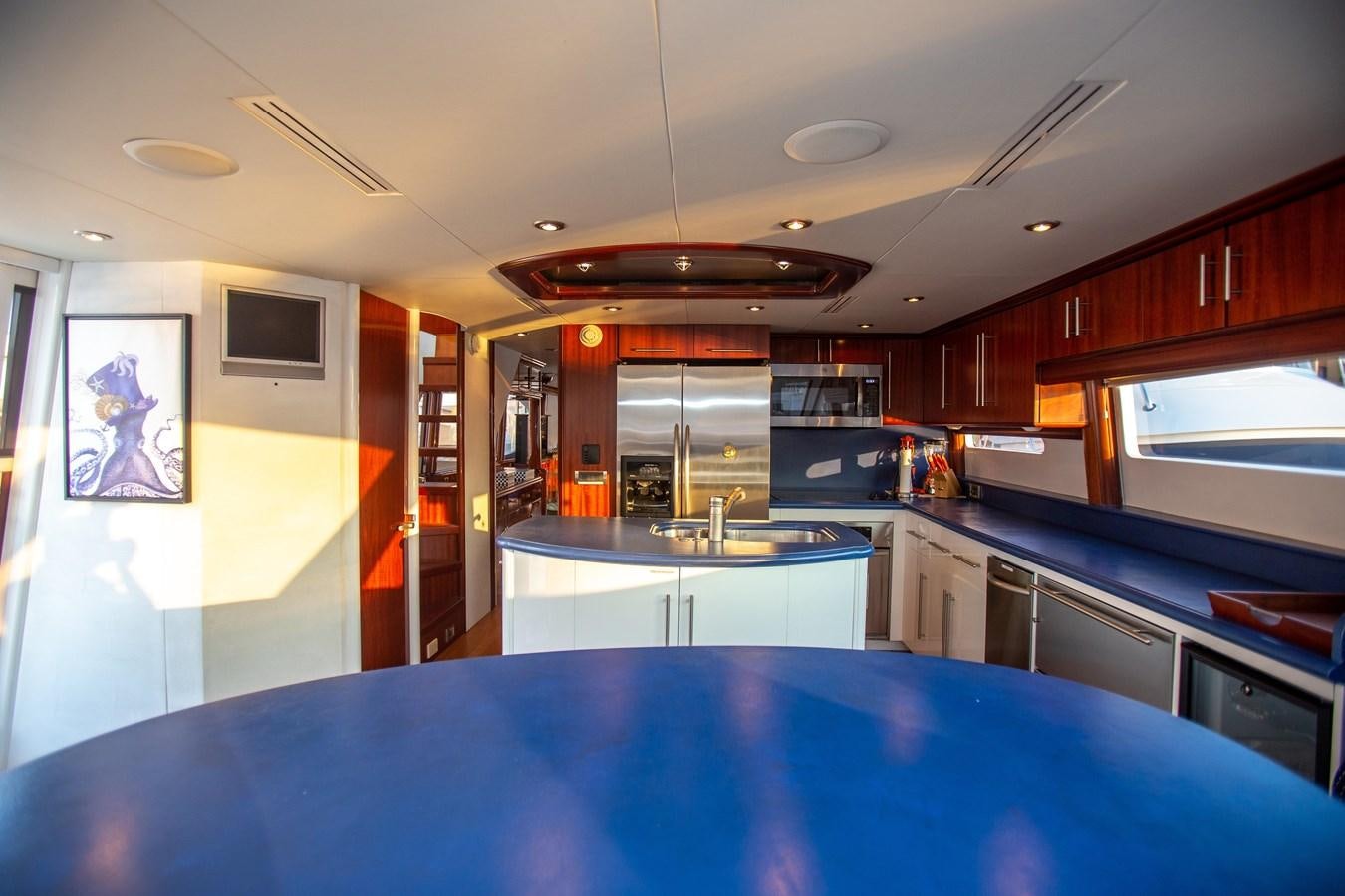 a kitchen with a large island aboard LAZZARA 80' Yacht for Sale