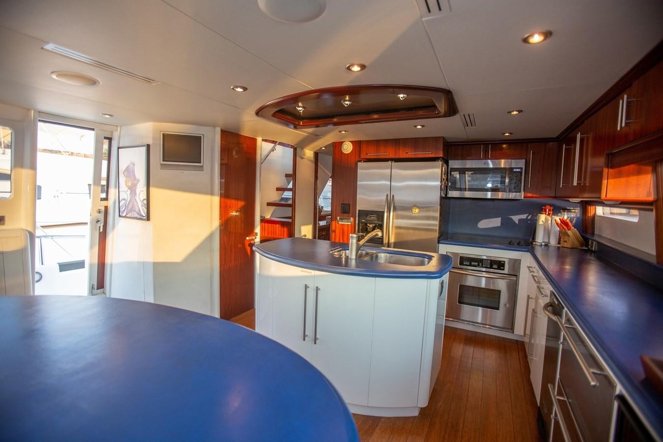 a kitchen with a blue counter aboard LAZZARA 80' Yacht for Sale