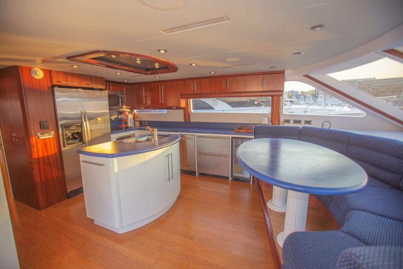 a kitchen with a table and chairs aboard LAZZARA 80' Yacht for Sale