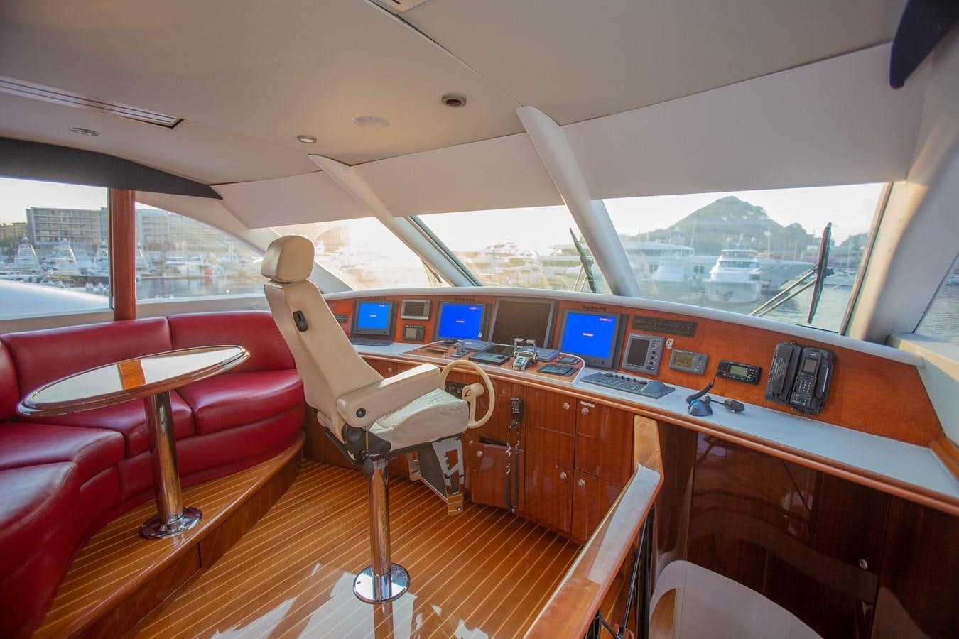 a room with a desk and chairs aboard LAZZARA 80' Yacht for Sale