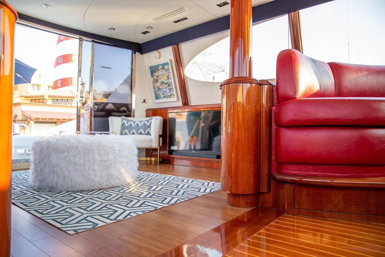 a living room with a fireplace aboard LAZZARA 80' Yacht for Sale