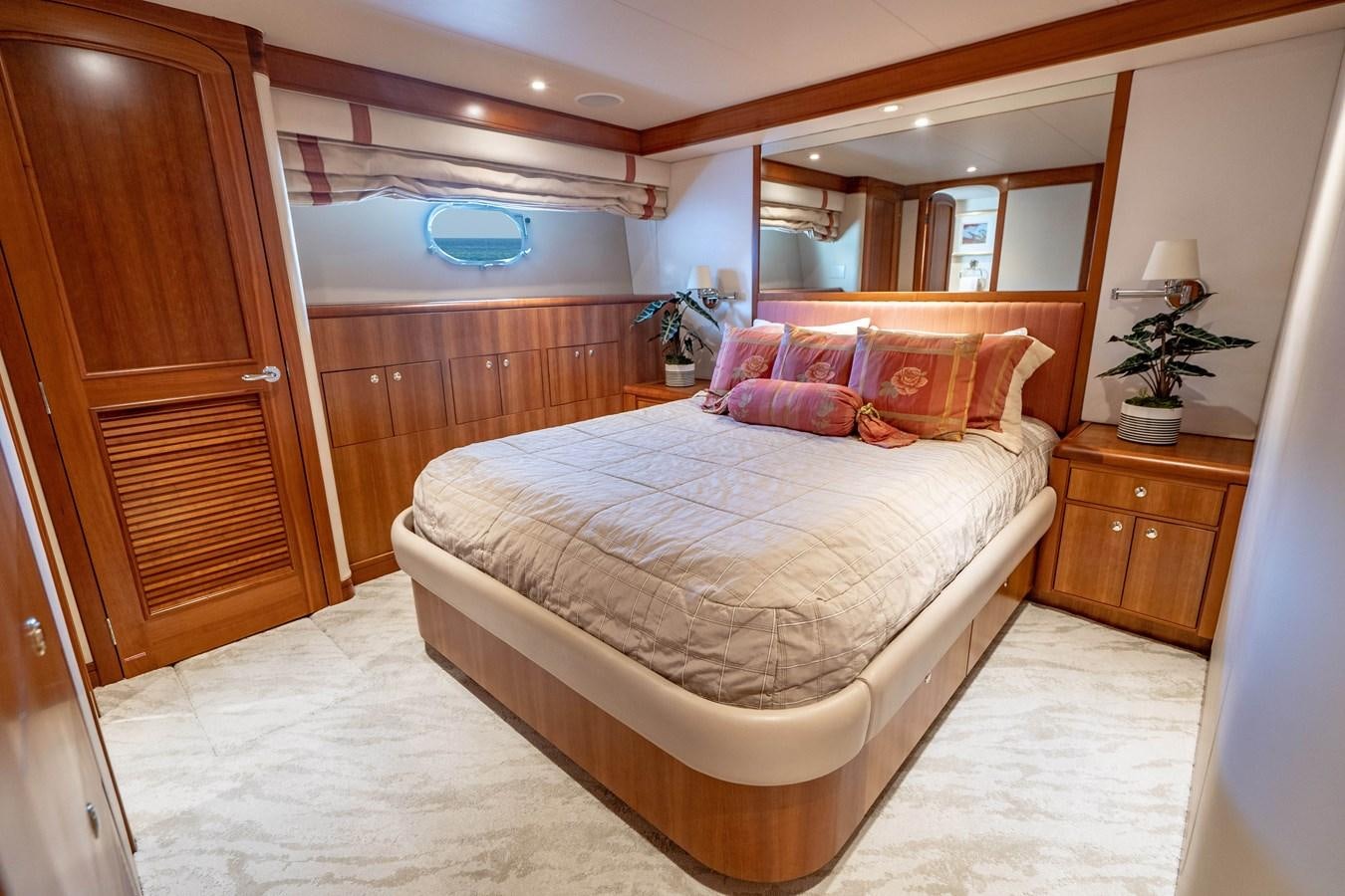 a bedroom with a bed and a closet aboard SHORT GAME Yacht for Sale