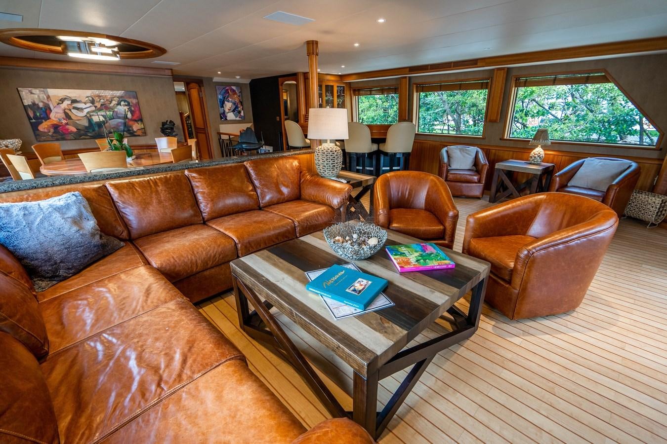 a living room with leather couches and a coffee table aboard SHORT GAME Yacht for Sale