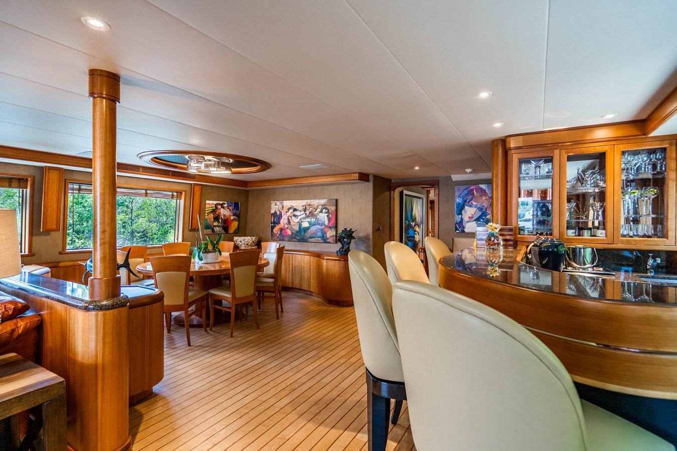 a large room with tables and chairs aboard SHORT GAME Yacht for Sale