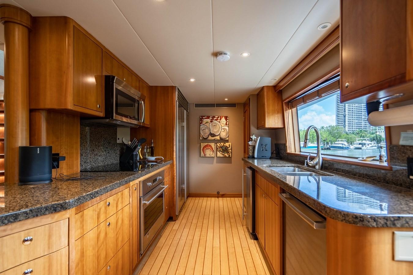a kitchen with wooden cabinets aboard SHORT GAME Yacht for Sale
