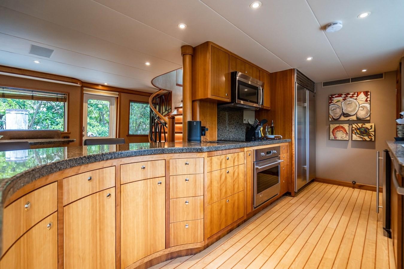 a kitchen with wooden cabinets aboard SHORT GAME Yacht for Sale