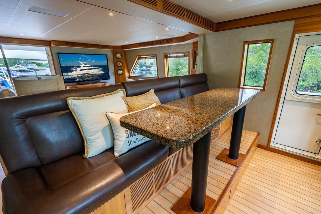 a living room with leather couches aboard SHORT GAME Yacht for Sale