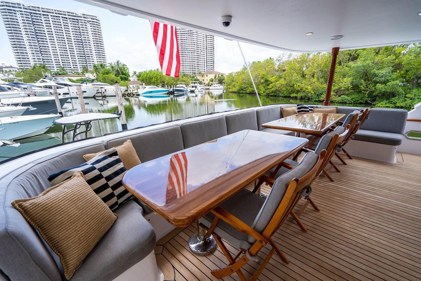 a deck with chairs and tables aboard SHORT GAME Yacht for Sale