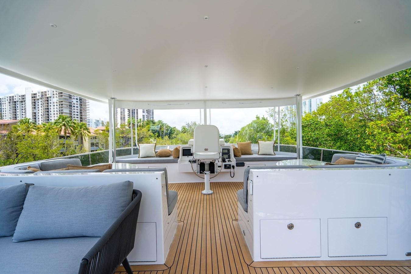 a large white room with a wood floor and a large window aboard SHORT GAME Yacht for Sale