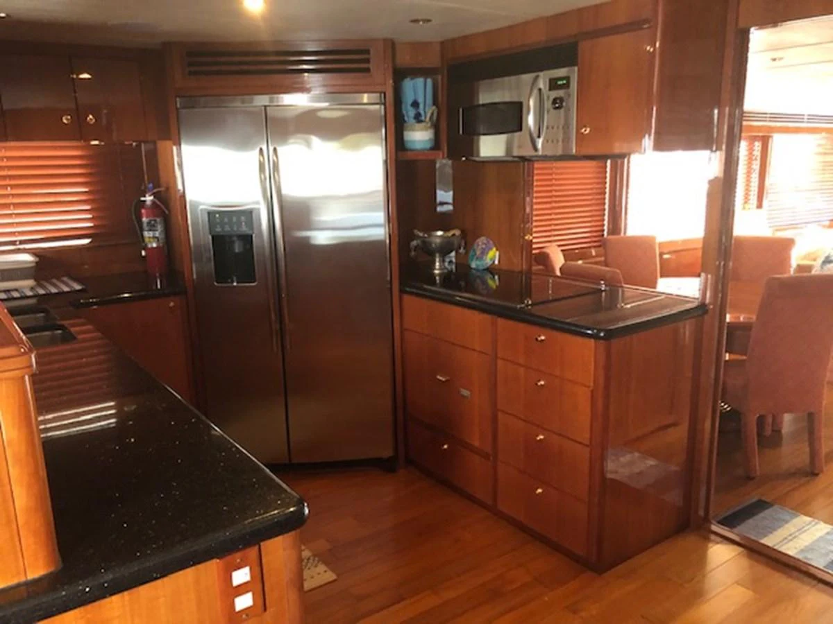 a kitchen with a stainless steel refrigerator aboard JEF82110L506 Yacht for Sale