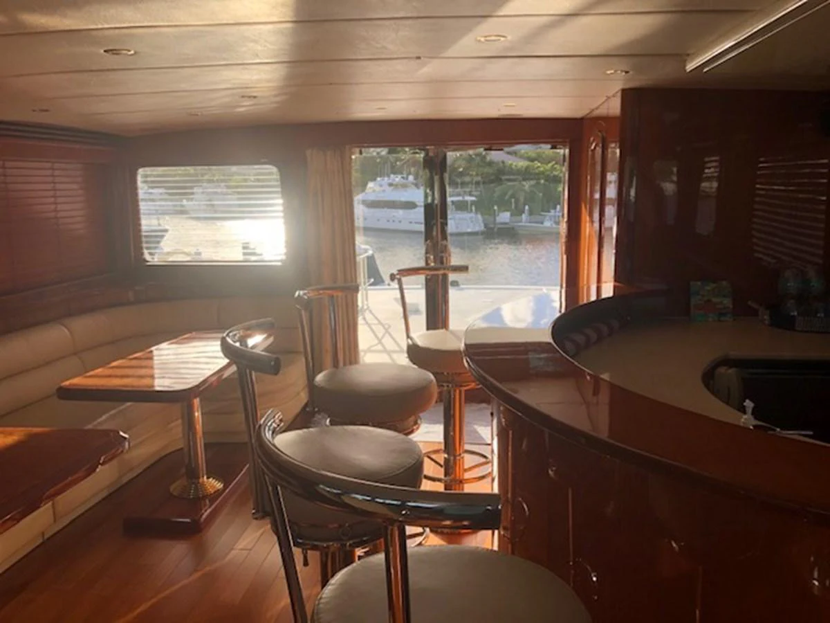 a room with tables and chairs aboard JEF82110L506 Yacht for Sale
