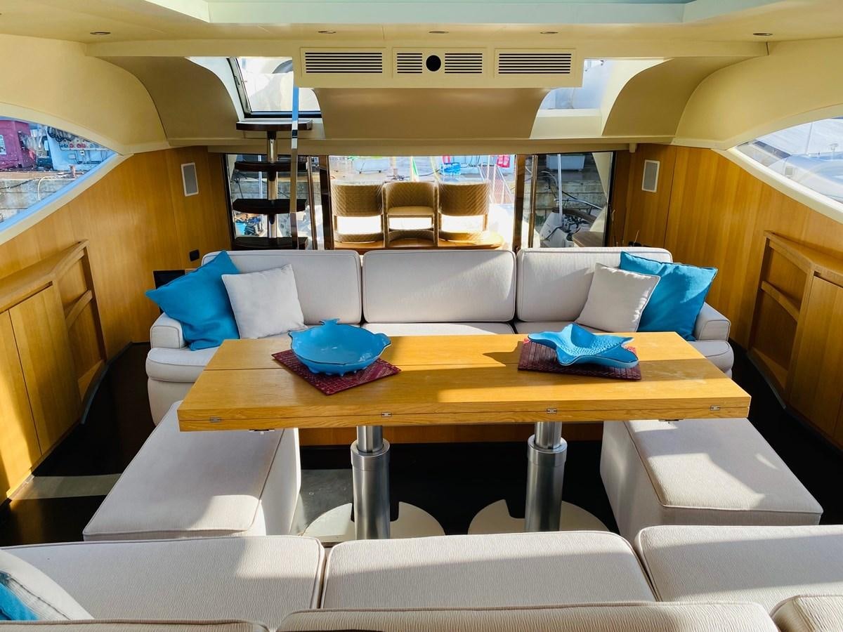 a room with a table and chairs aboard DEA Yacht for Sale