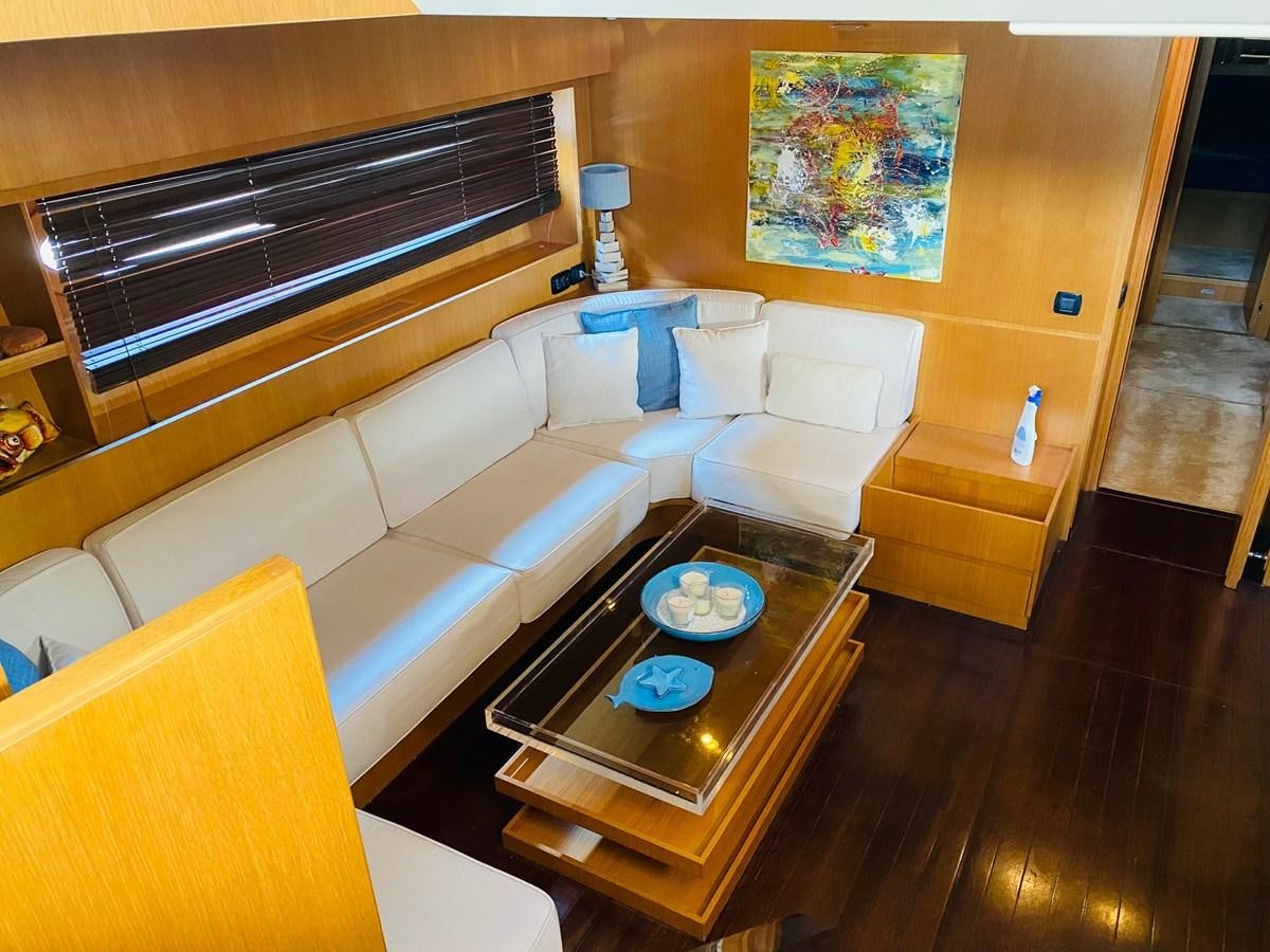 a living room with a couch and a coffee table aboard DEA Yacht for Sale