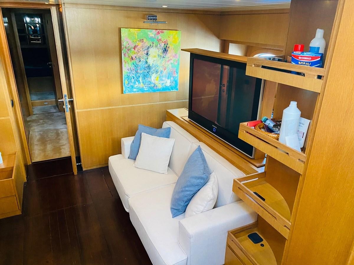 a room with a couch and a tv aboard DEA Yacht for Sale