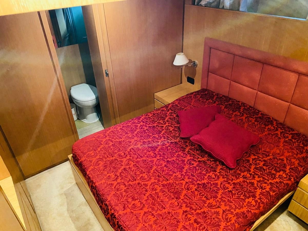 a bed with pink pillows aboard DEA Yacht for Sale