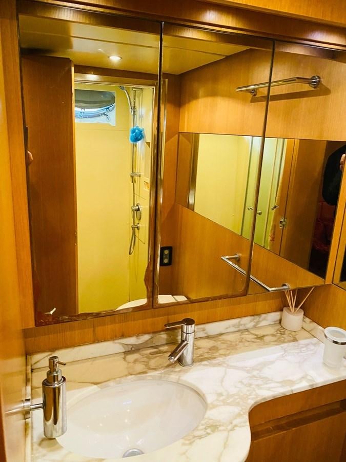 a bathroom with a large mirror aboard DEA Yacht for Sale