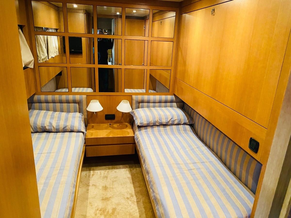 a room with a bed and a table aboard DEA Yacht for Sale