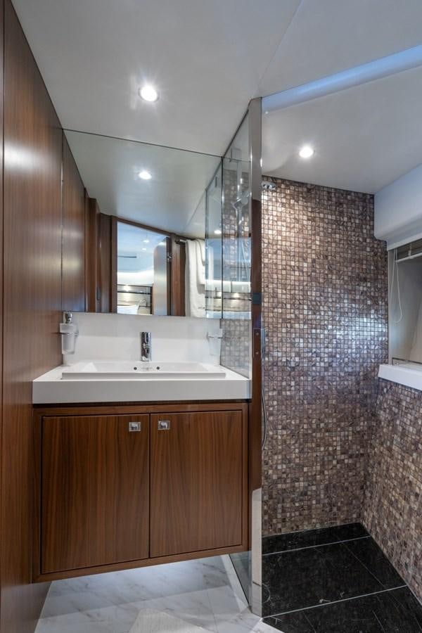 a bathroom with a sink and a mirror aboard SOL INVICTUS Yacht for Sale