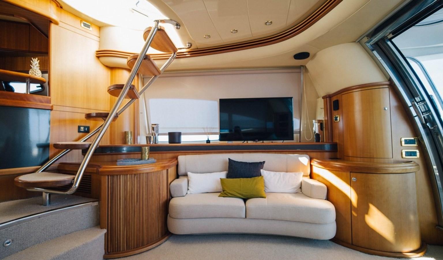a living room with a couch and a tv aboard FOUNDATION  Yacht for Sale