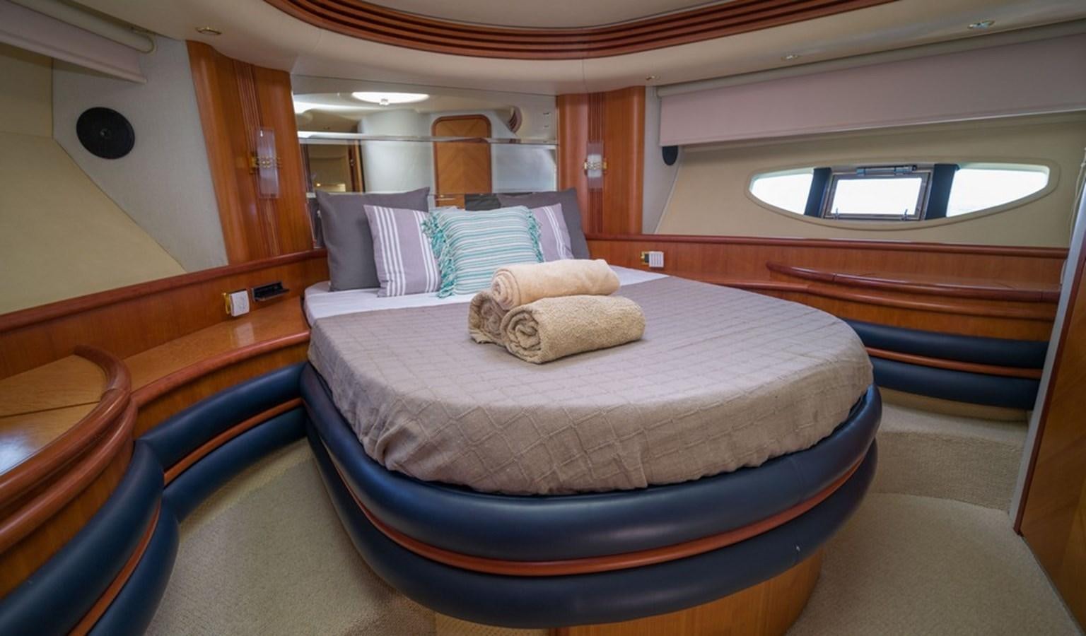 a room with a bed and a window aboard FOUNDATION  Yacht for Sale