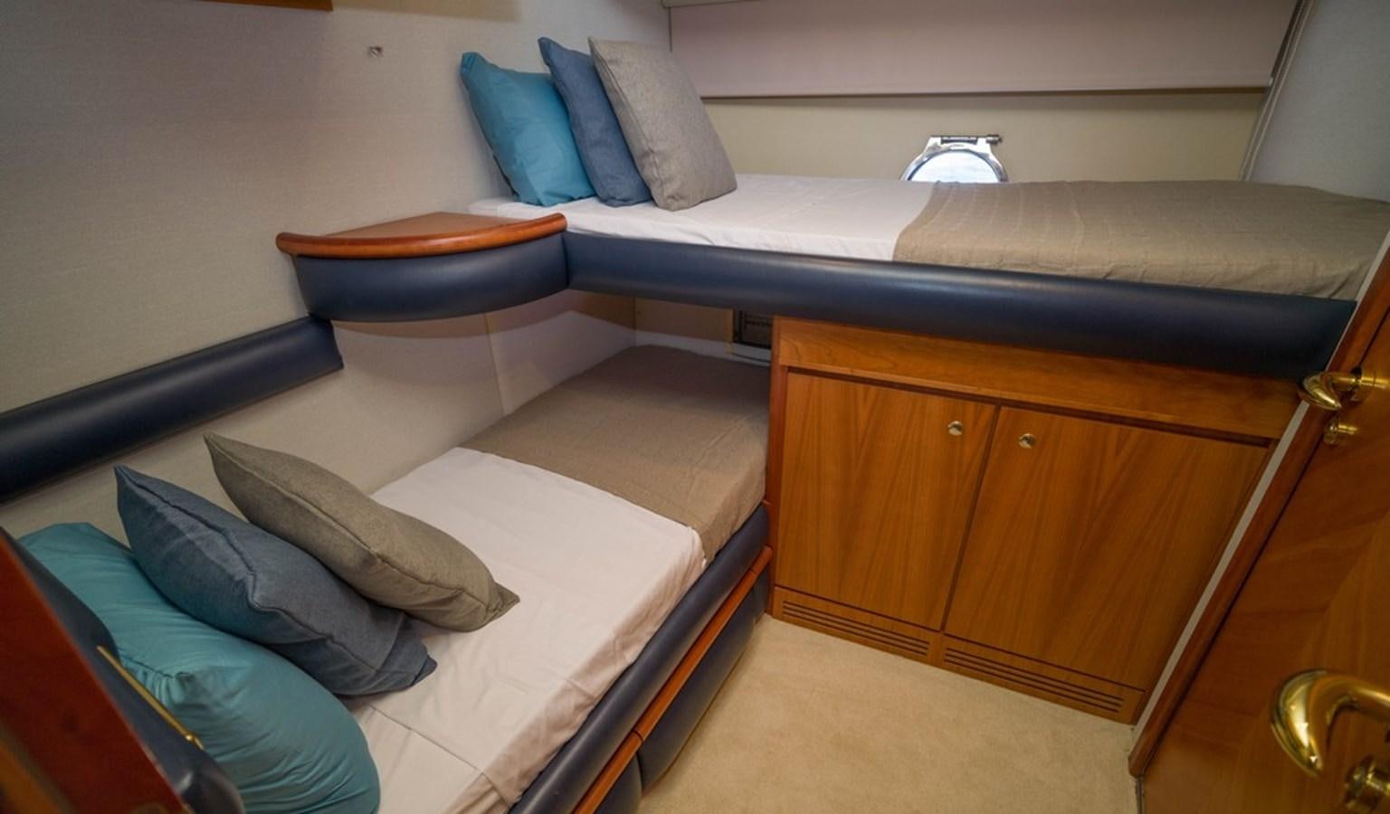 a bed with a blue pillow aboard FOUNDATION  Yacht for Sale