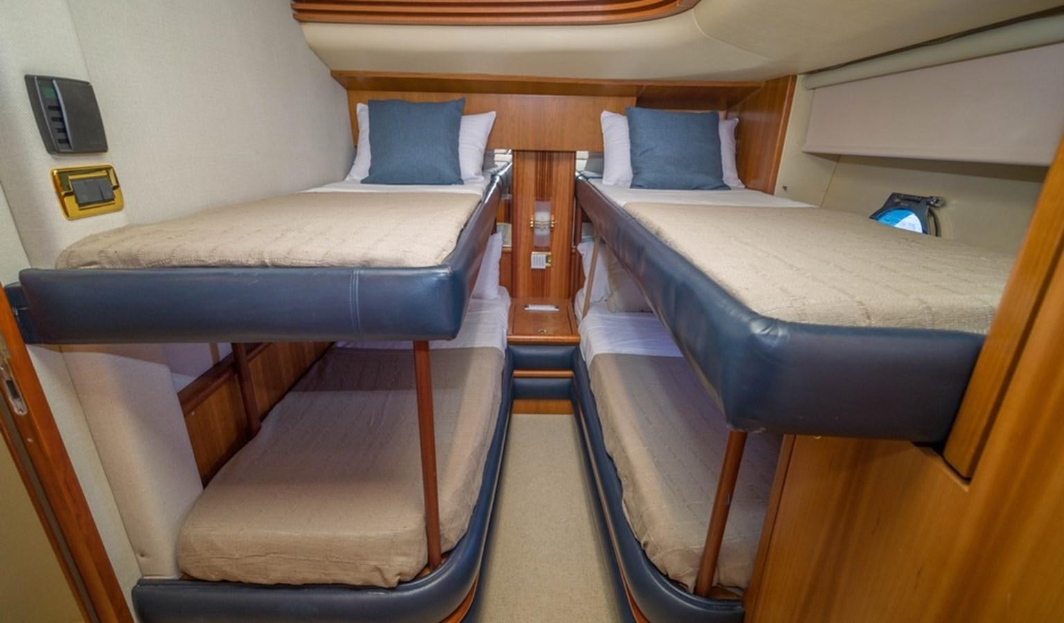 a room with beds and a couch aboard FOUNDATION  Yacht for Sale