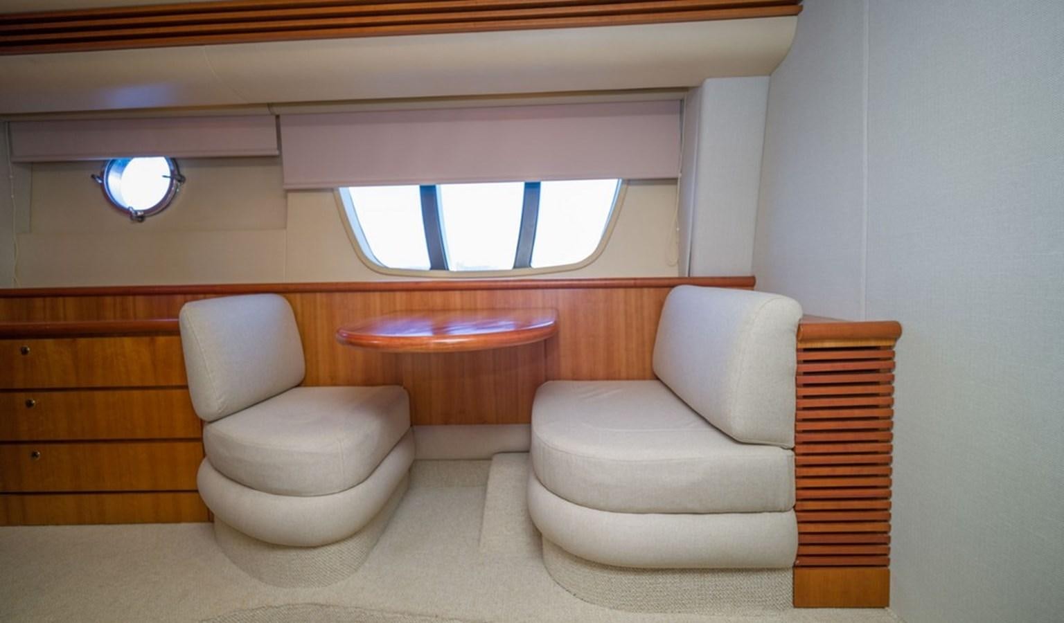 a room with a couch and a window aboard FOUNDATION  Yacht for Sale