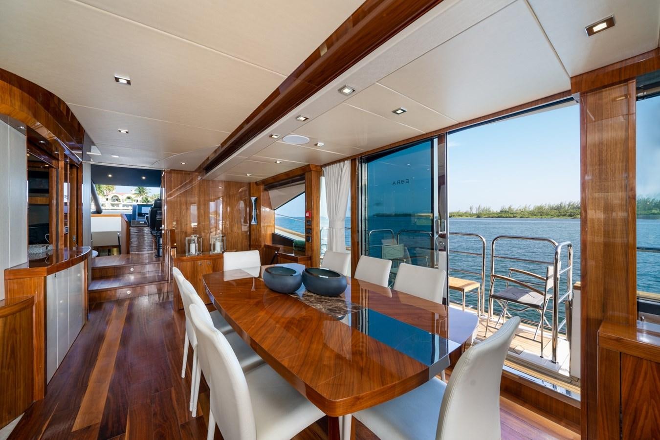 a large room with a table and chairs aboard 2015 SUNSEEKER 92' Yacht for Sale