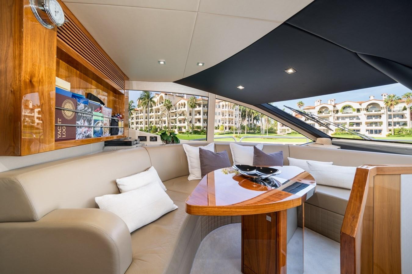 a living room with a table and couches aboard 2015 SUNSEEKER 92' Yacht for Sale