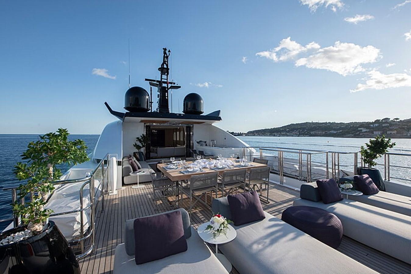 a deck with a large metal structure on it and a table with chairs on it aboard NEXT Yacht for Sale