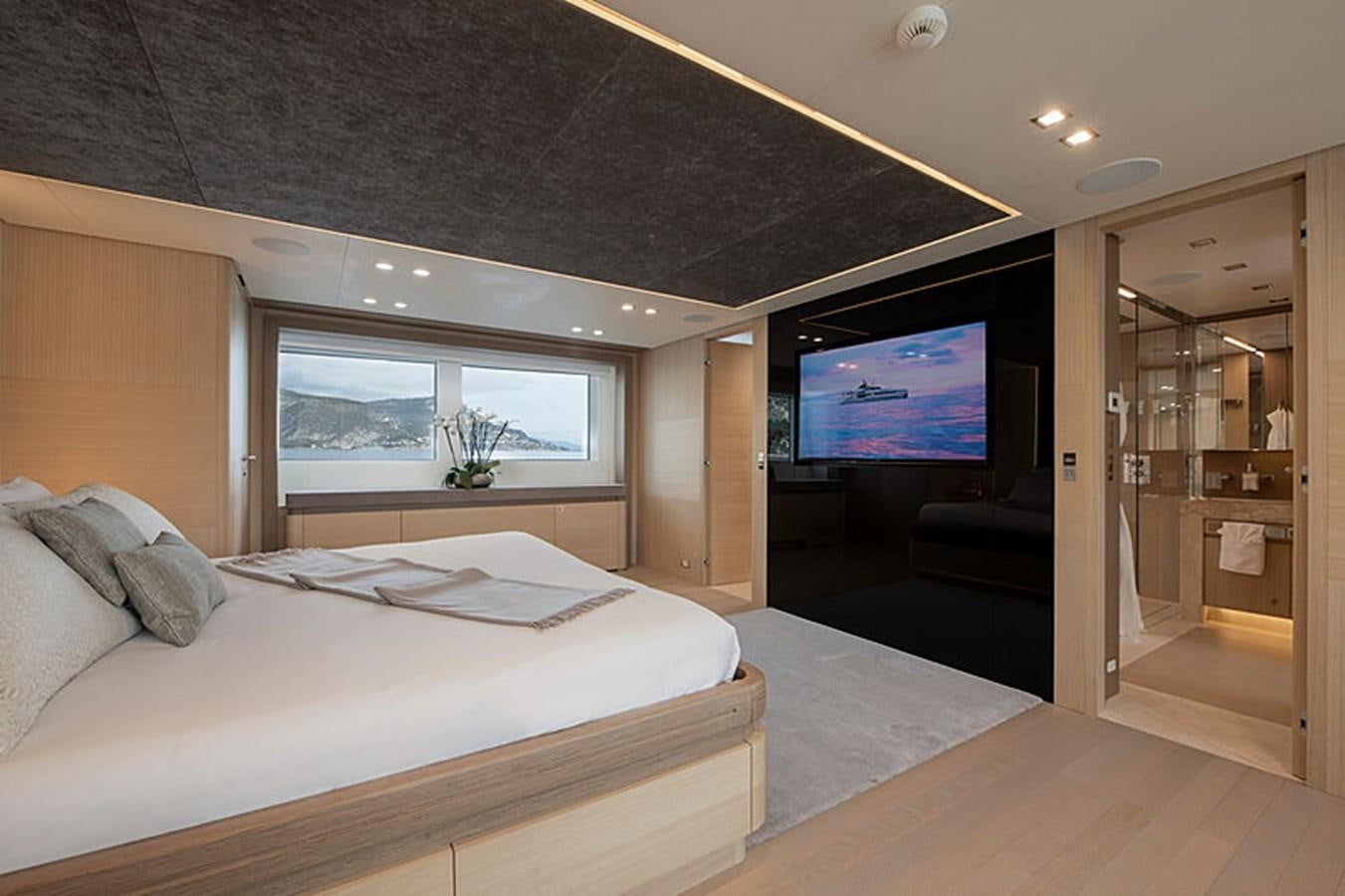 a bedroom with a large tv aboard NEXT Yacht for Sale