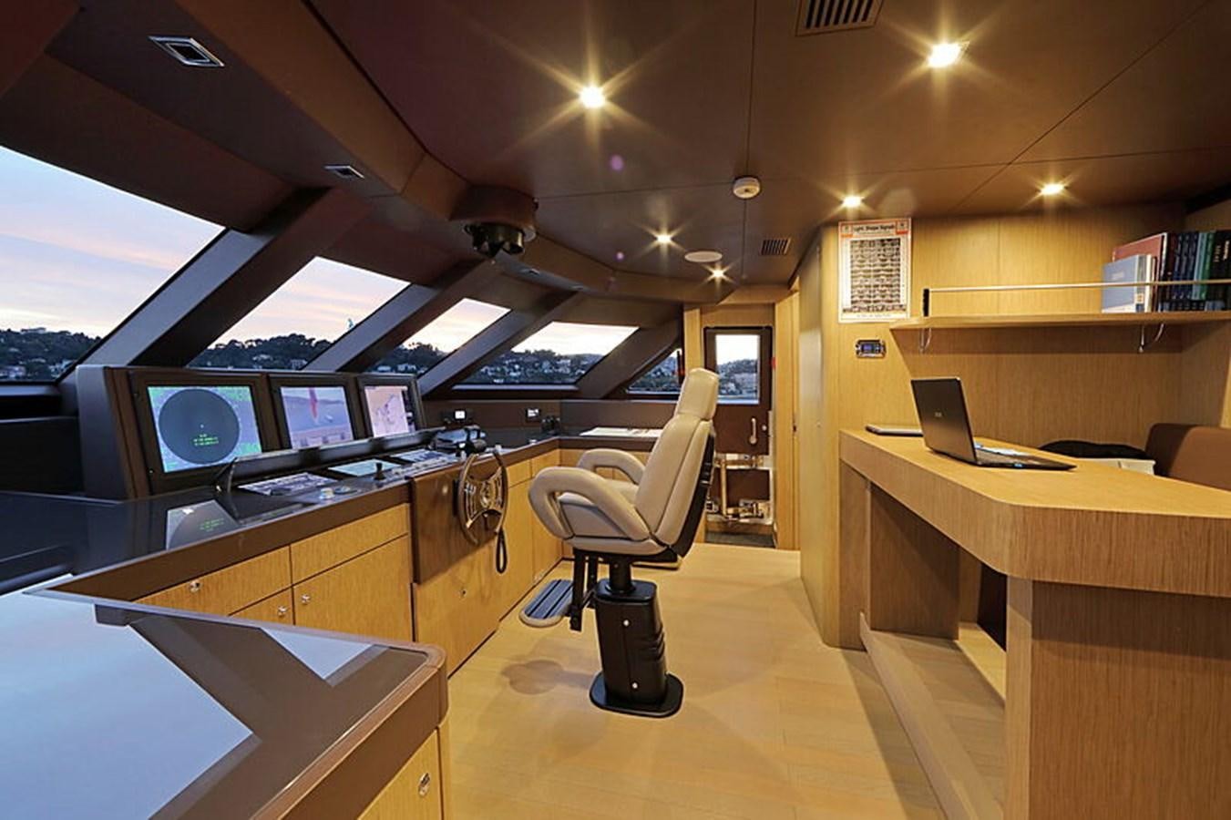 a room with computers and chairs aboard NEXT Yacht for Sale