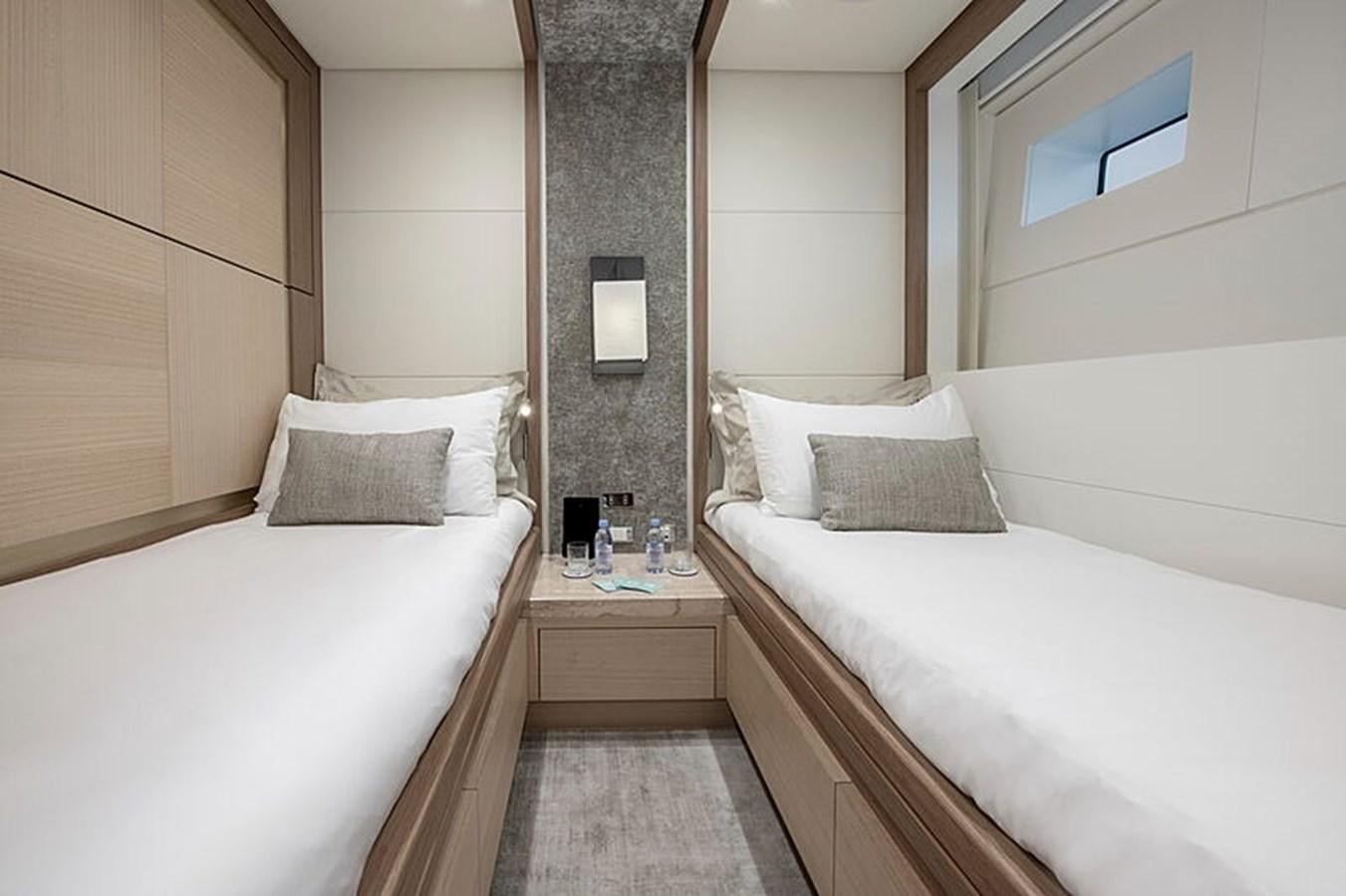 a room with two beds aboard NEXT Yacht for Sale