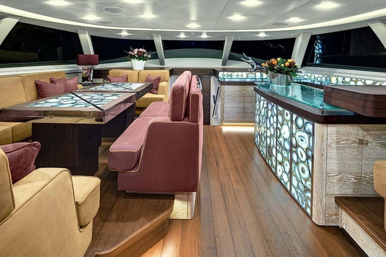 a room with a table and chairs aboard ESCAPADE Yacht for Sale