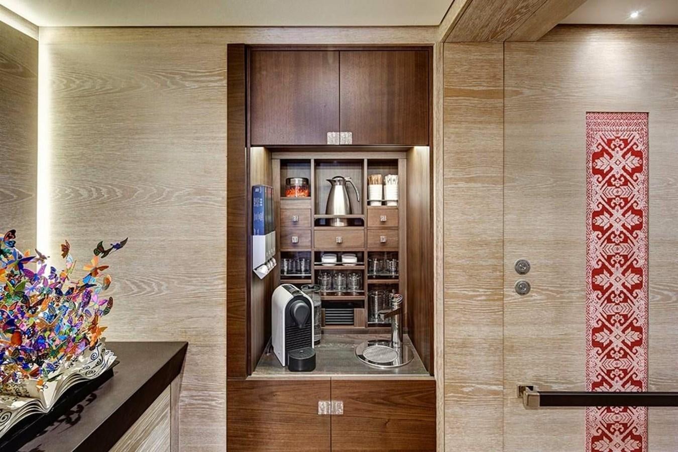 a room with a cabinet and a television aboard ESCAPADE Yacht for Sale