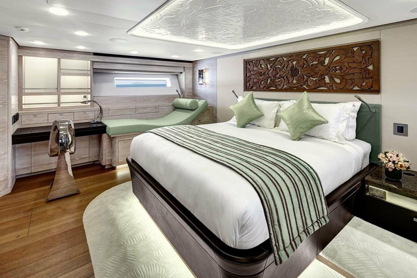 a bedroom with a bed and a desk aboard ESCAPADE Yacht for Sale