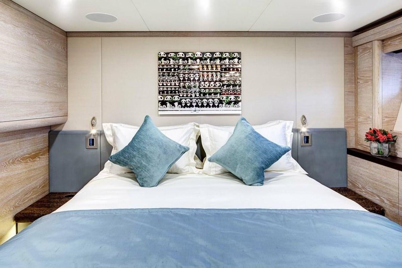 a bed with blue sheets aboard ESCAPADE Yacht for Sale