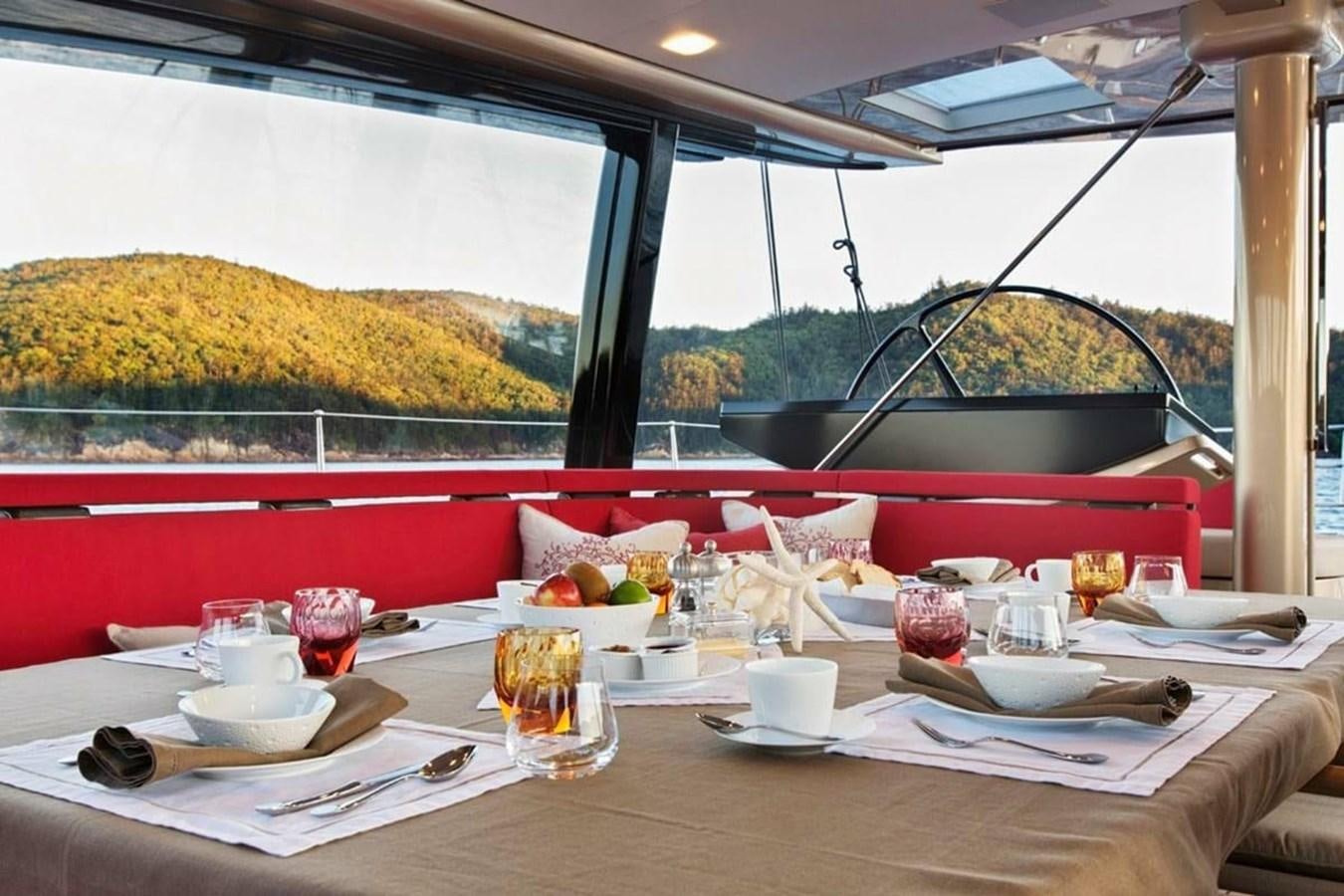 a table with food and drinks aboard ESCAPADE Yacht for Sale