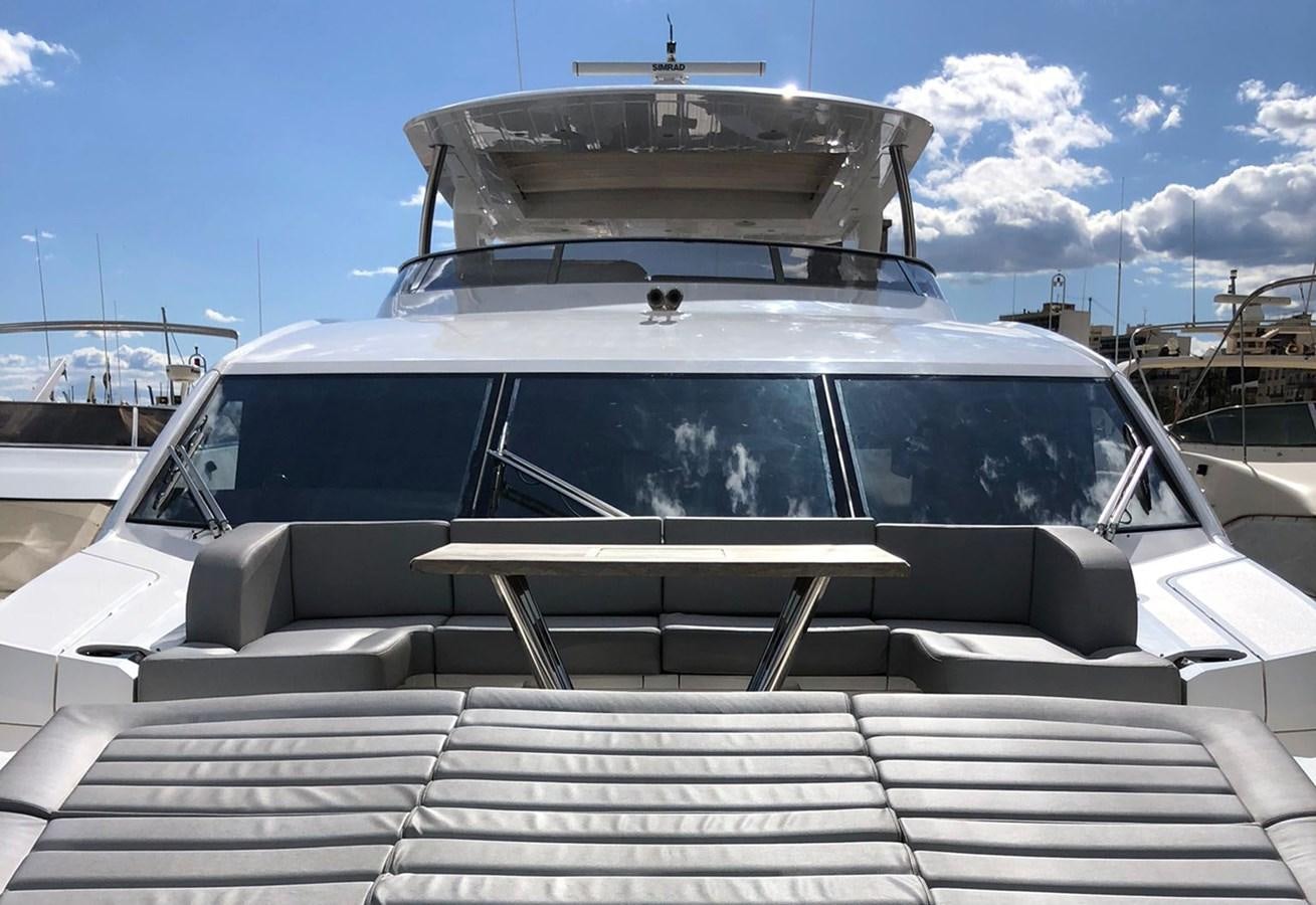 a white car with a deck and a boat on top aboard TICKETYBOO Yacht for Sale