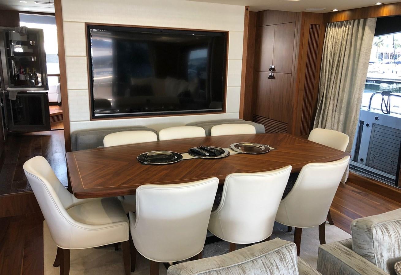 a table with chairs and a television aboard TICKETYBOO Yacht for Sale