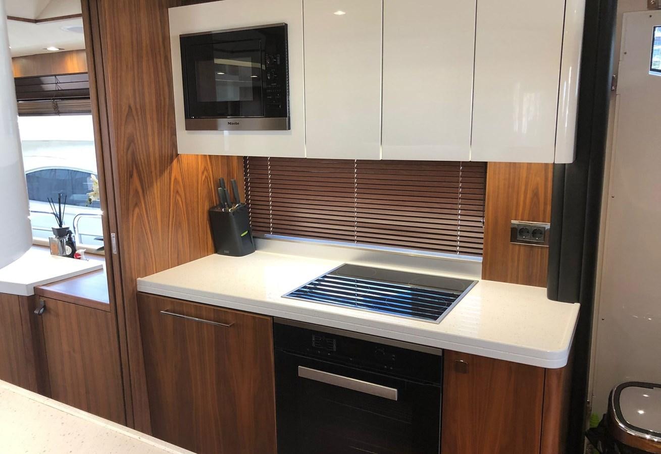 a kitchen with a stove and microwave aboard TICKETYBOO Yacht for Sale