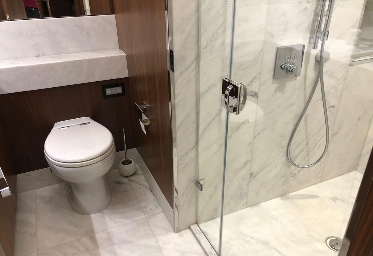 a bathroom with a glass shower aboard TICKETYBOO Yacht for Sale