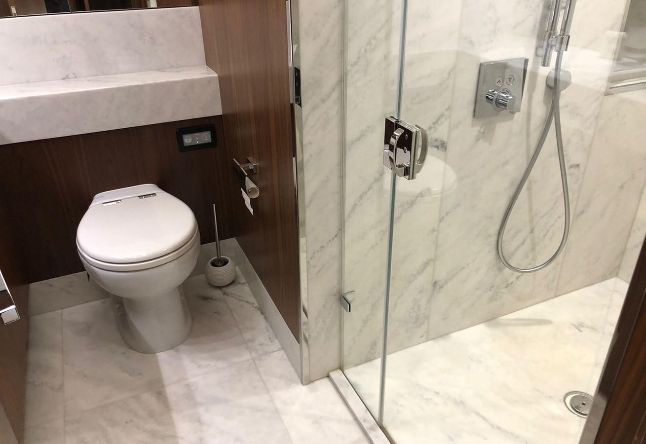 a bathroom with a glass shower aboard TICKETYBOO Yacht for Sale