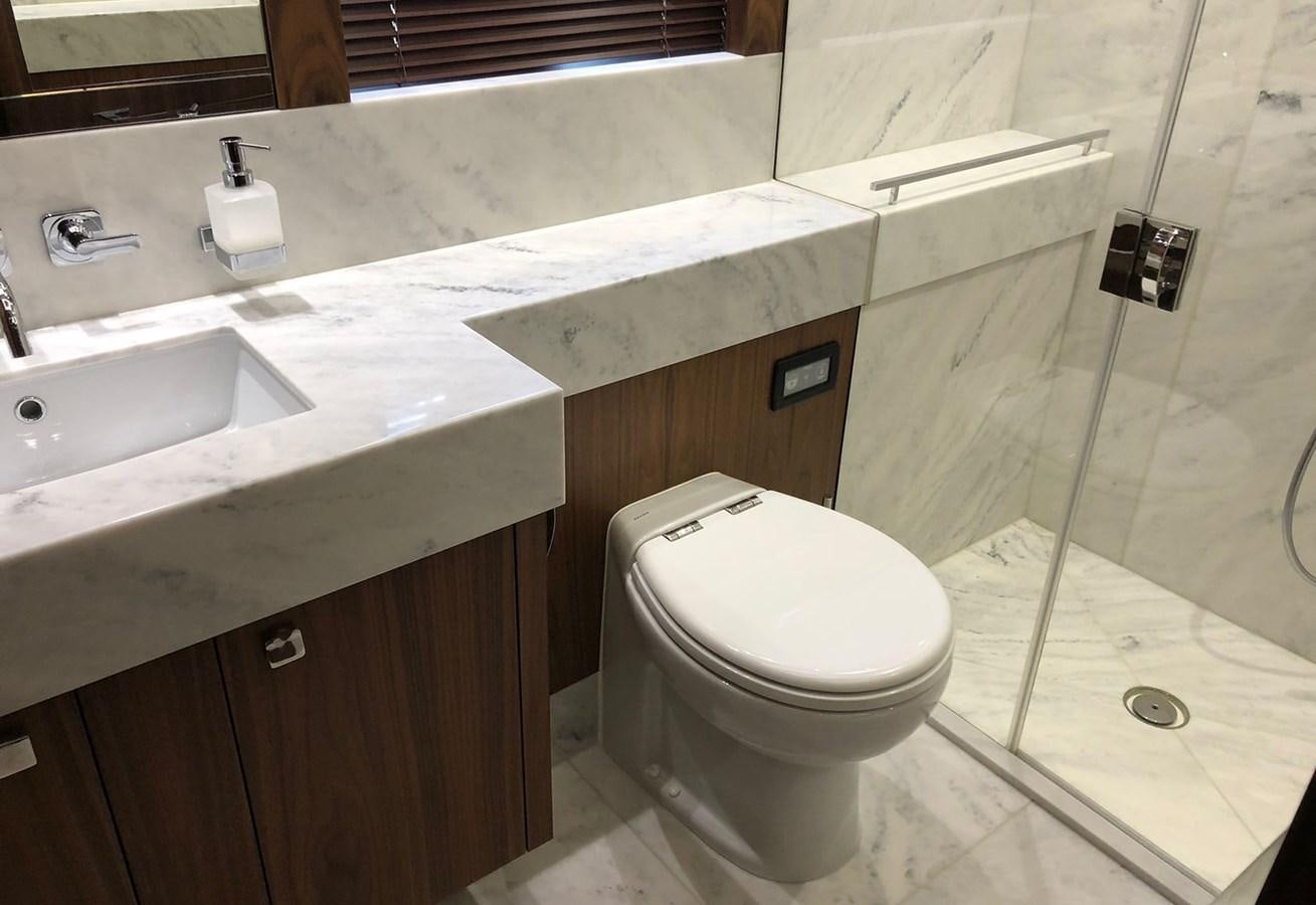 a bathroom with a toilet and sink aboard TICKETYBOO Yacht for Sale